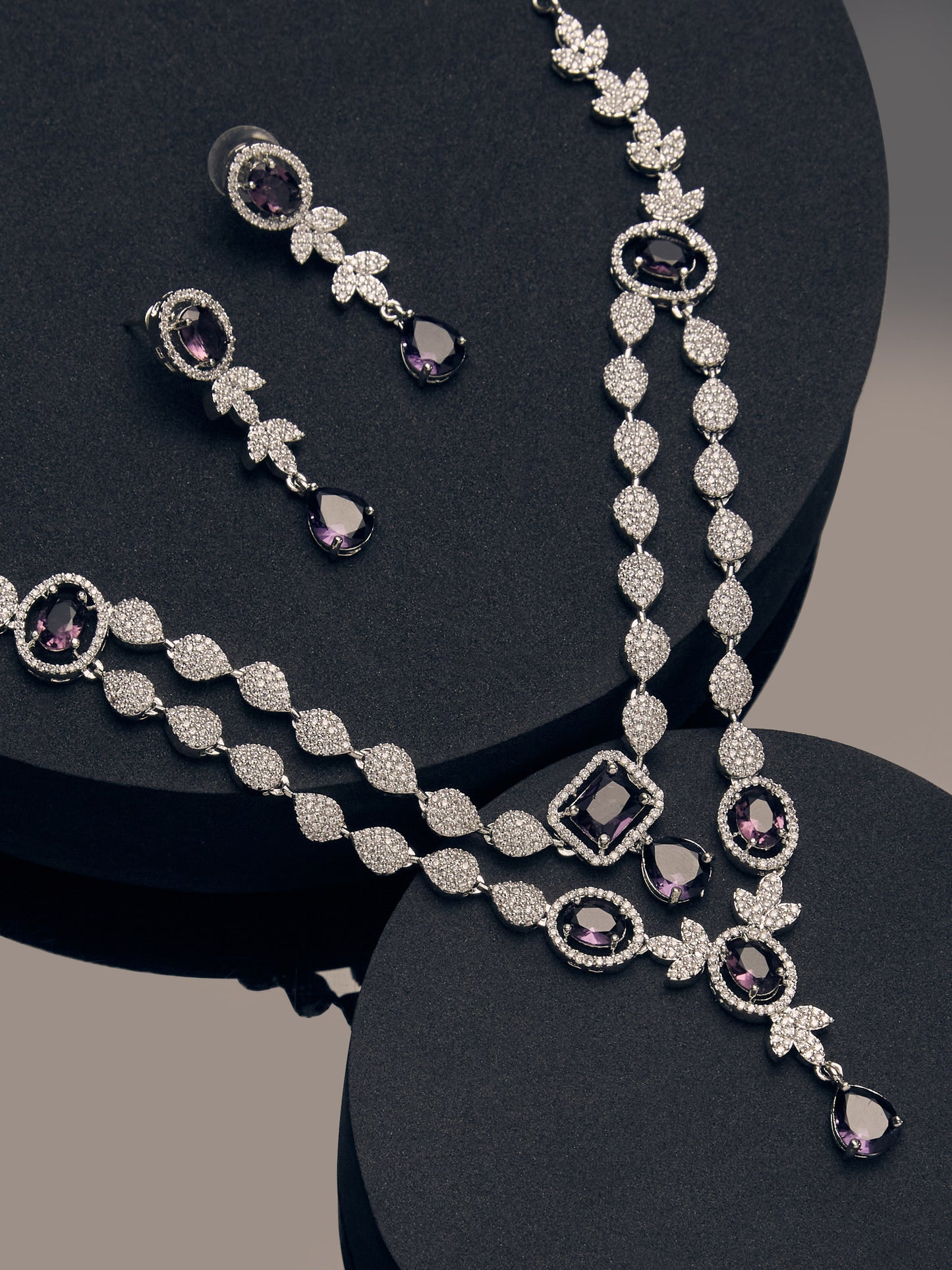 rhodium-plated double-layered necklace set with purple and white CZ stones and matching drop earrings