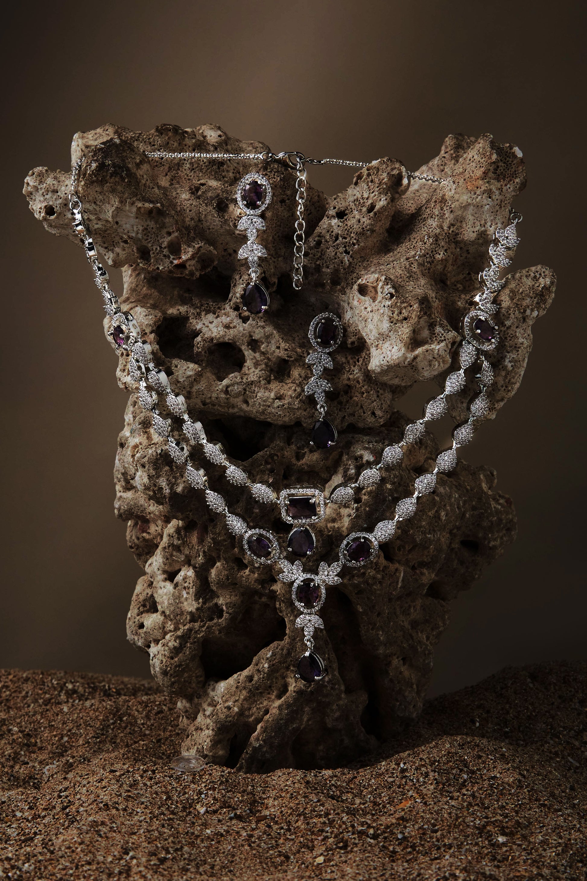 rhodium-plated double-layered necklace set with purple and white CZ stones and matching drop earrings