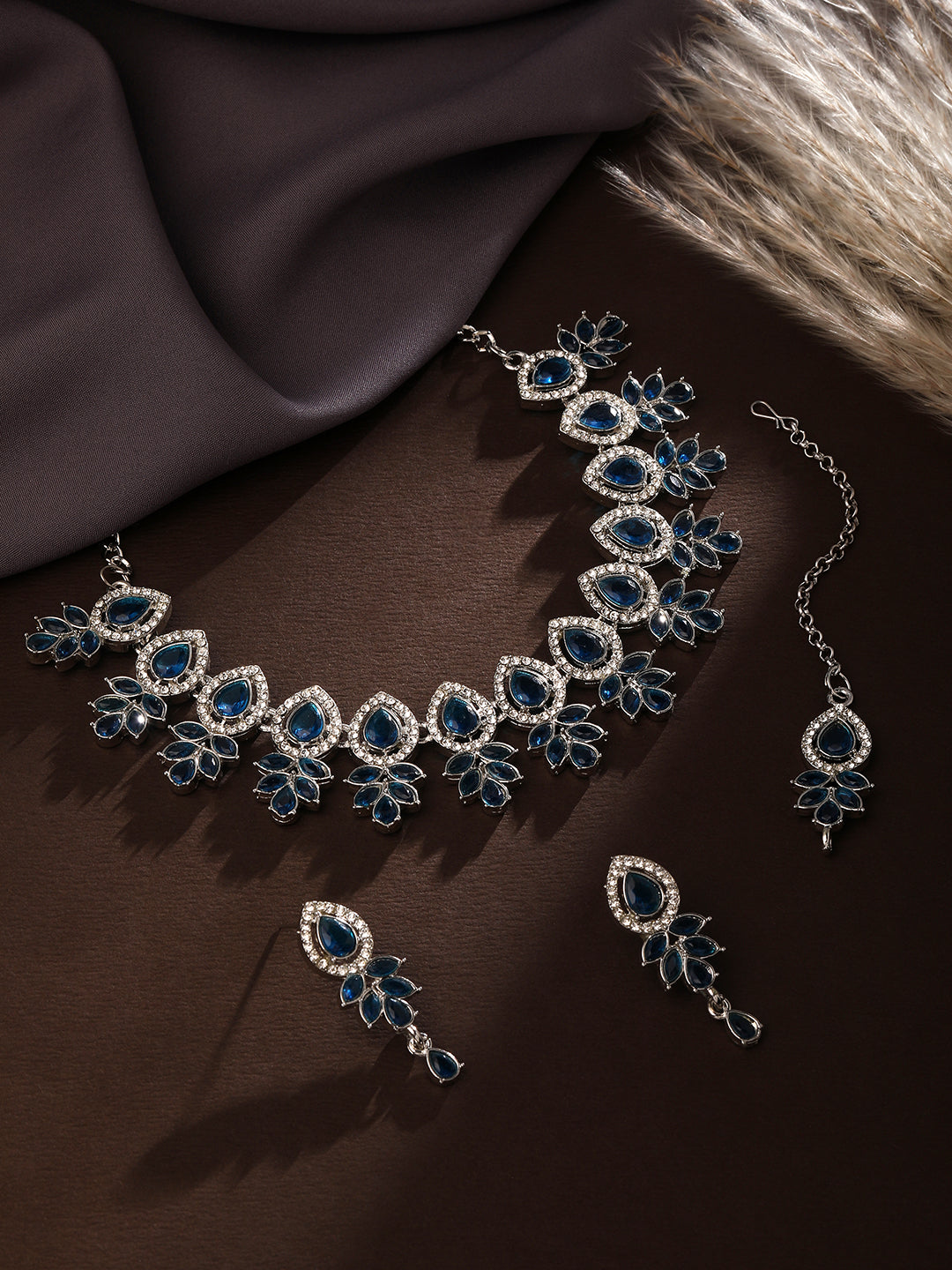 Rhodium plated blue stone choker jewellery set with matching earrings and maang tikka